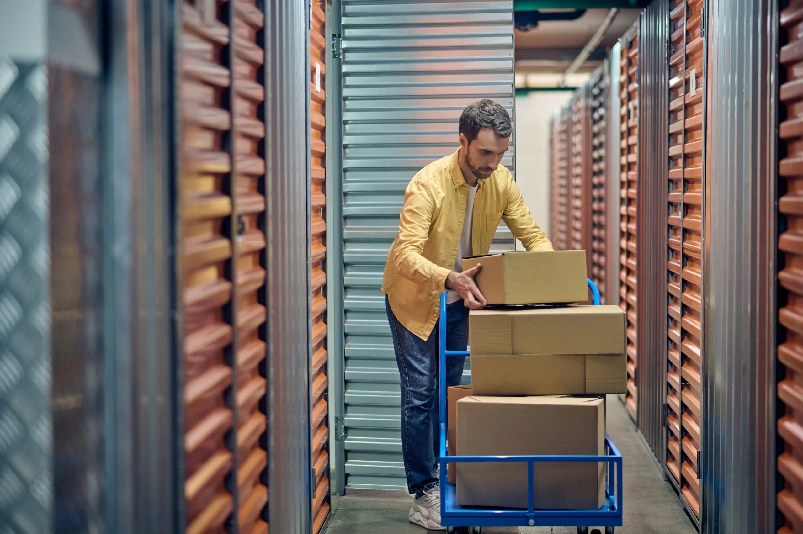order picker stacking cardboard boxes in hand truck